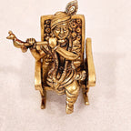Swinging Lord Shri Krishna on a rocking chair.