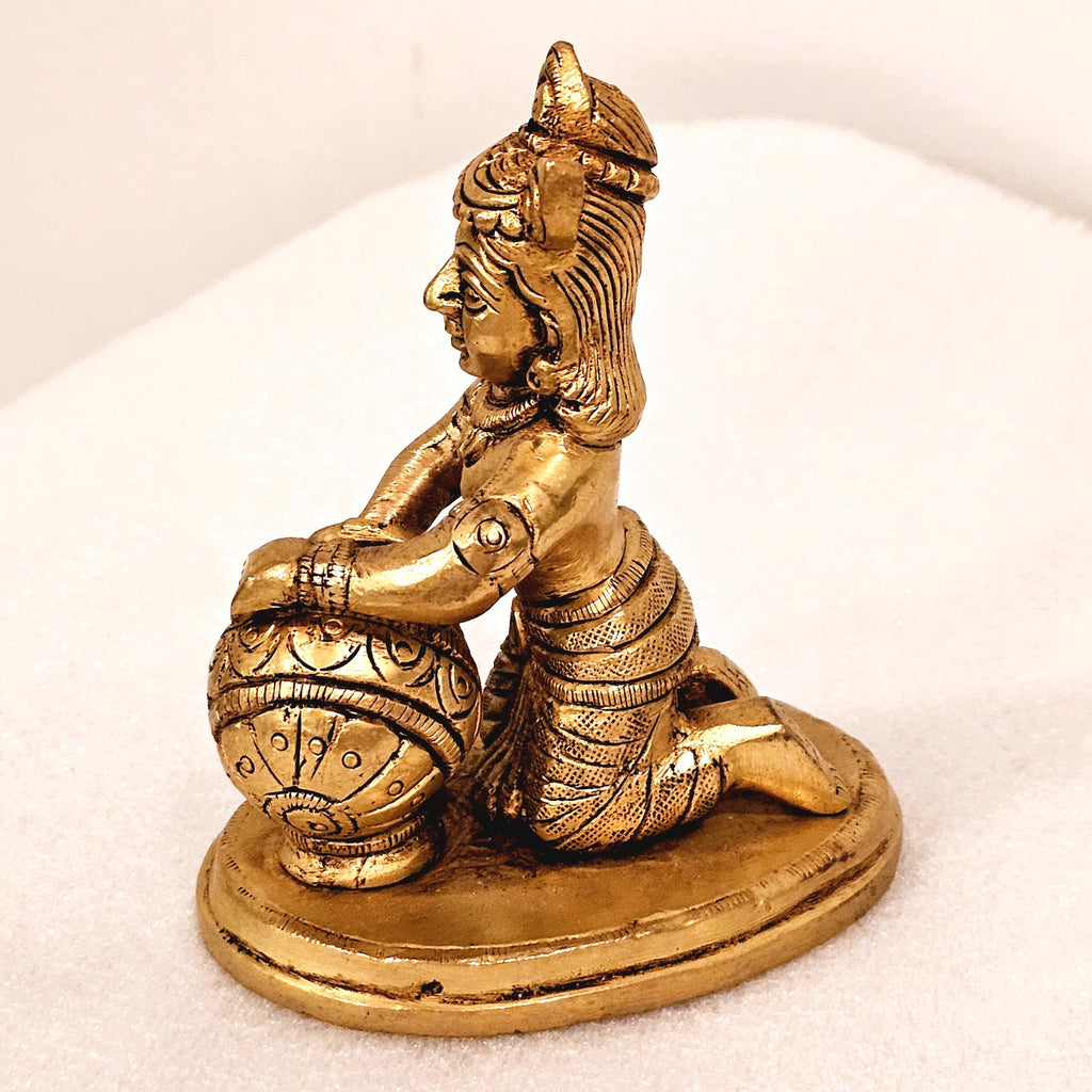Bala Krishna eating butter. | brass