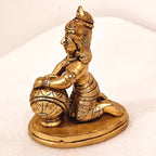 Bala Krishna eating butter. | brass