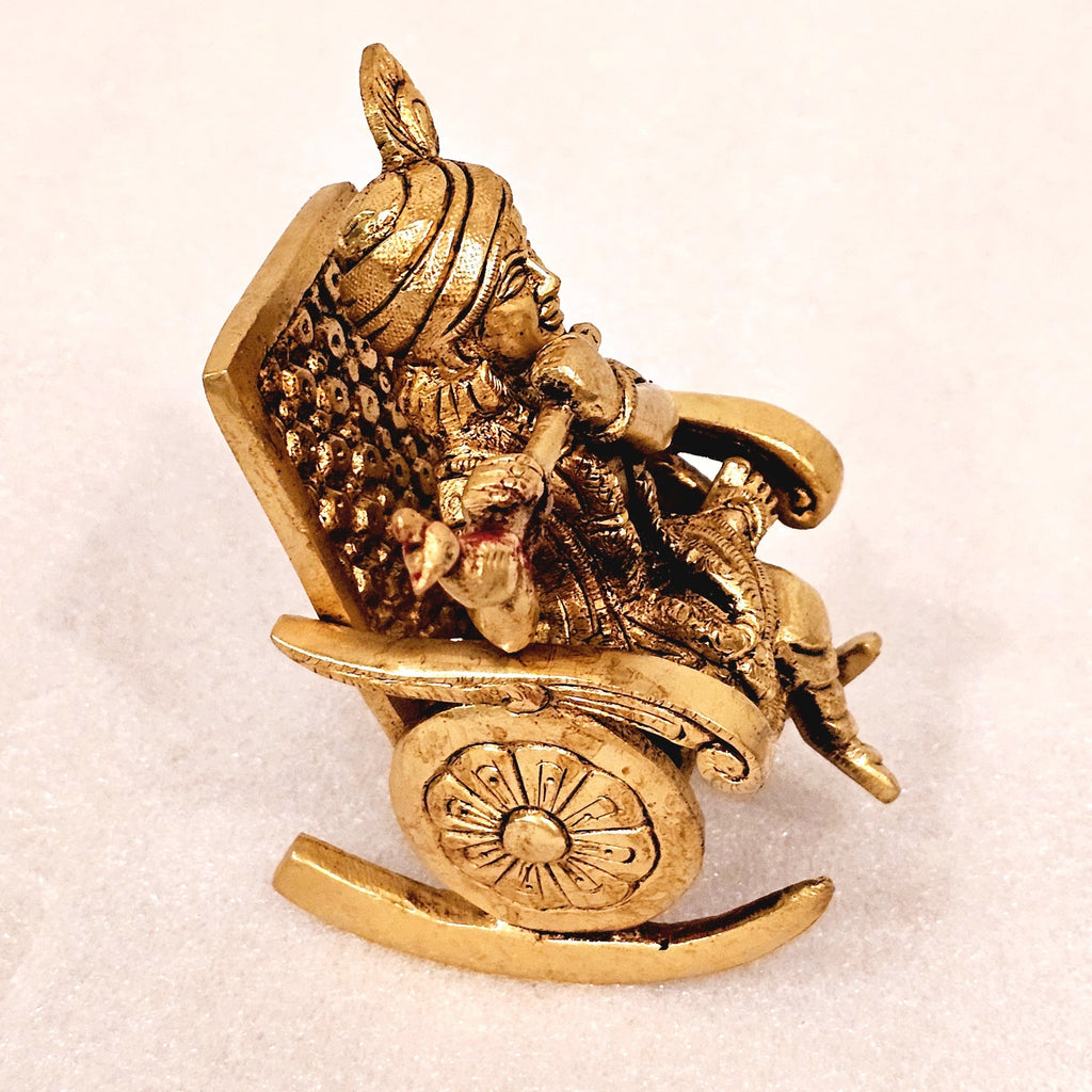 Swinging Lord Shri Krishna on a rocking chair.
