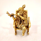 Swinging Lord Shri Krishna on a rocking chair.