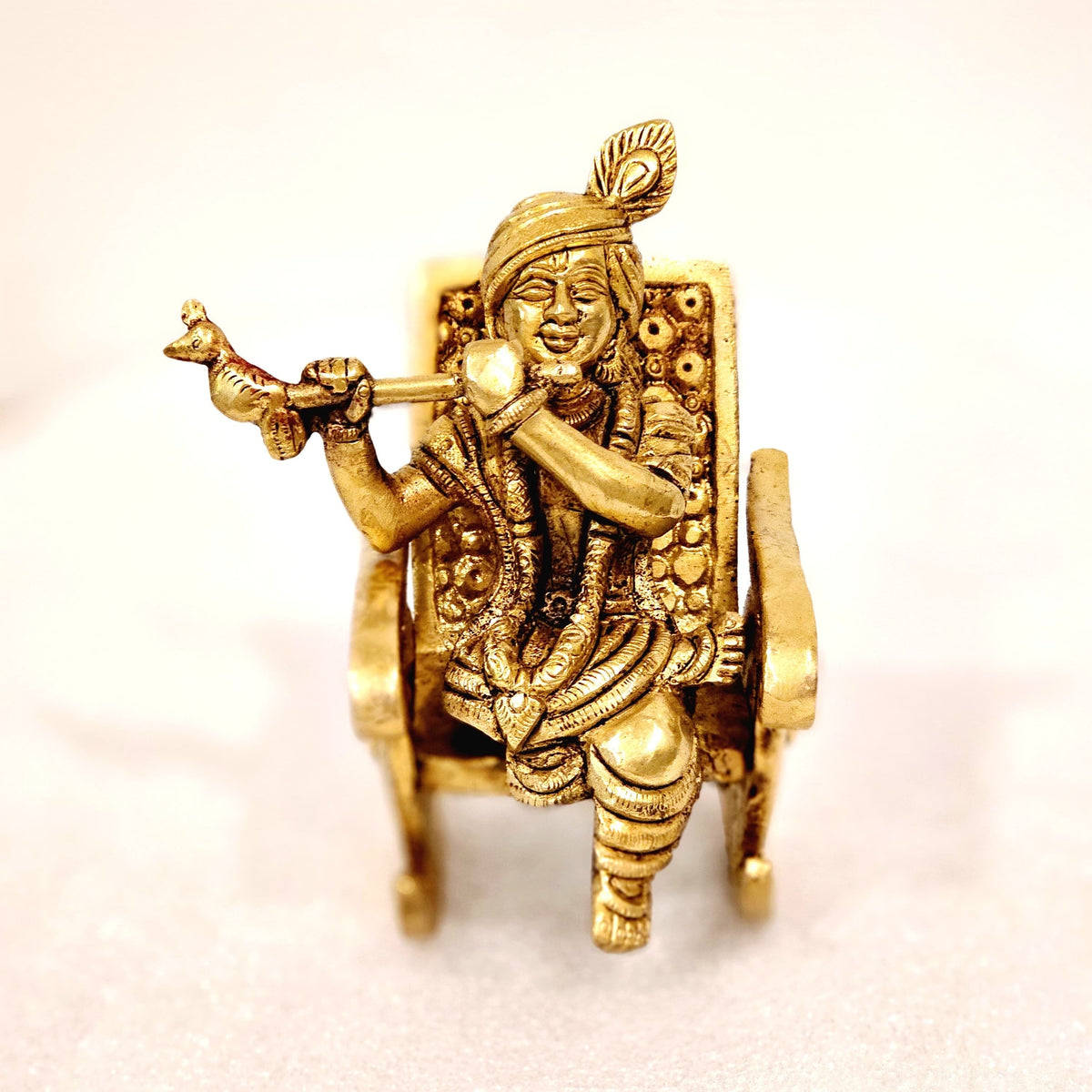 Swinging Lord Shri Krishna on a rocking chair.