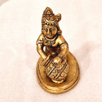 Bala Krishna eating butter. | brass